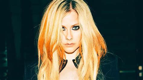 Avril Lavigne's fishnet and hotpants Versace look leaves fans reeling